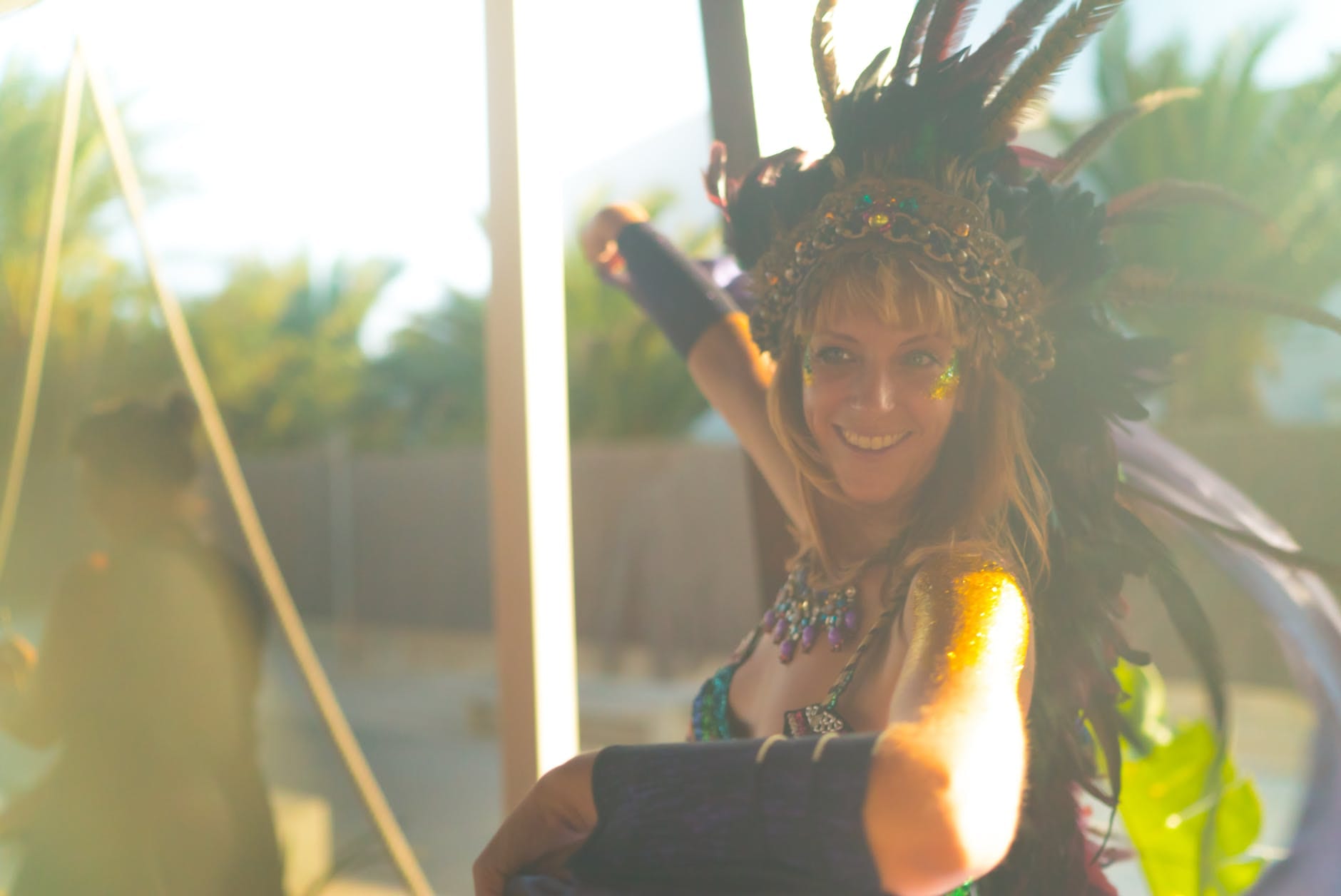 happiness is only real when shared header shows woman wearing blue spaghetti strap top with feather headdress