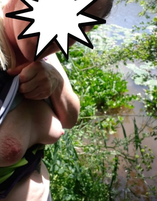 Naturally reserved, but with Breasts exposed at a nature reserve.
