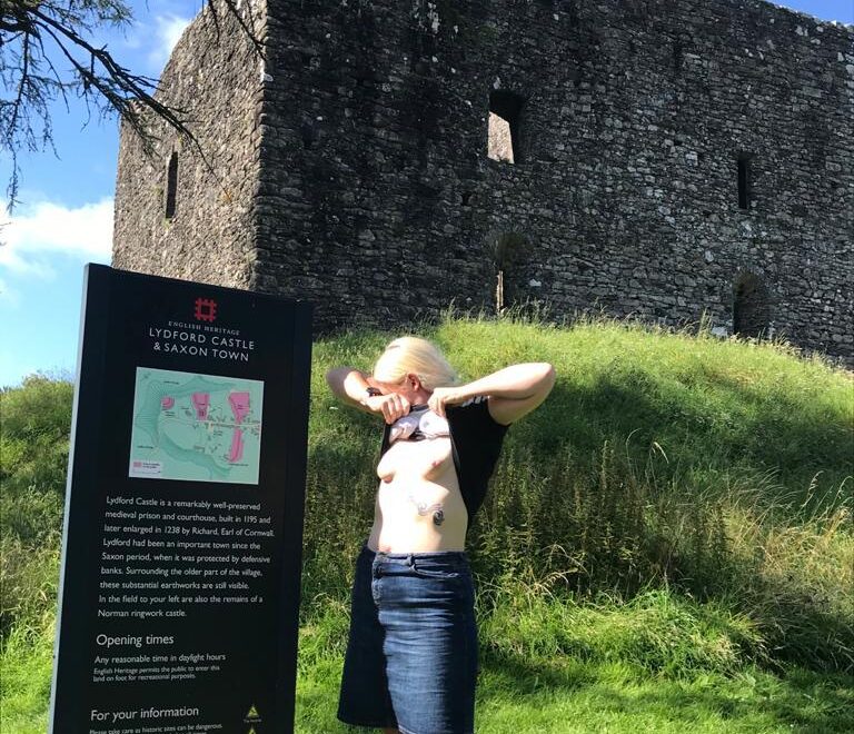 Stone by stone a castle header, lady exposing her breasts in front of a castle