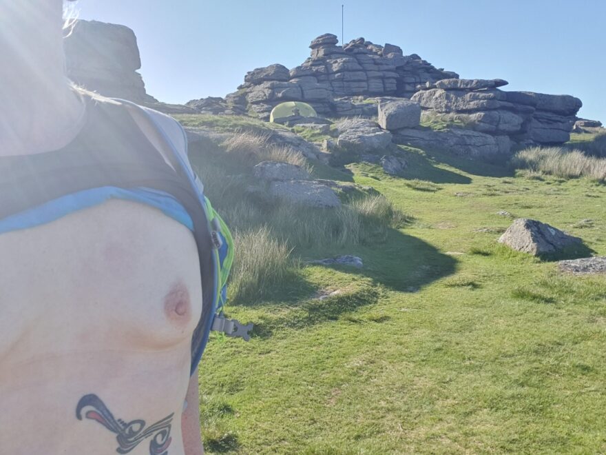 Breasts exposed atop Great Mis Tor for wild camping on Dartmoor. A sunny evening, a 2 man tent and boobs!
