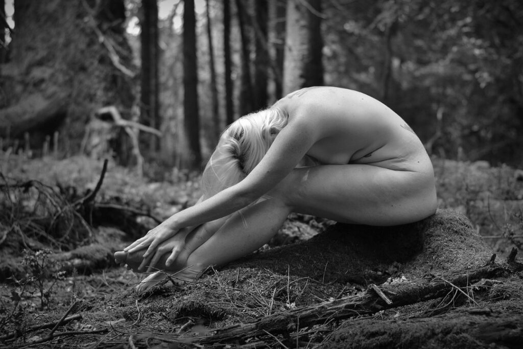 My own personal wilderness header, calm nude and peaceful barefoot sub, she is sitting on a tree stump, folded over her legs. 