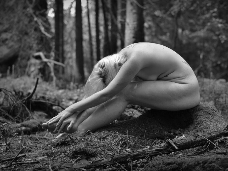 My own personal wilderness header, calm nude and peaceful barefoot sub, she is sitting on a tree stump, folded over her legs.