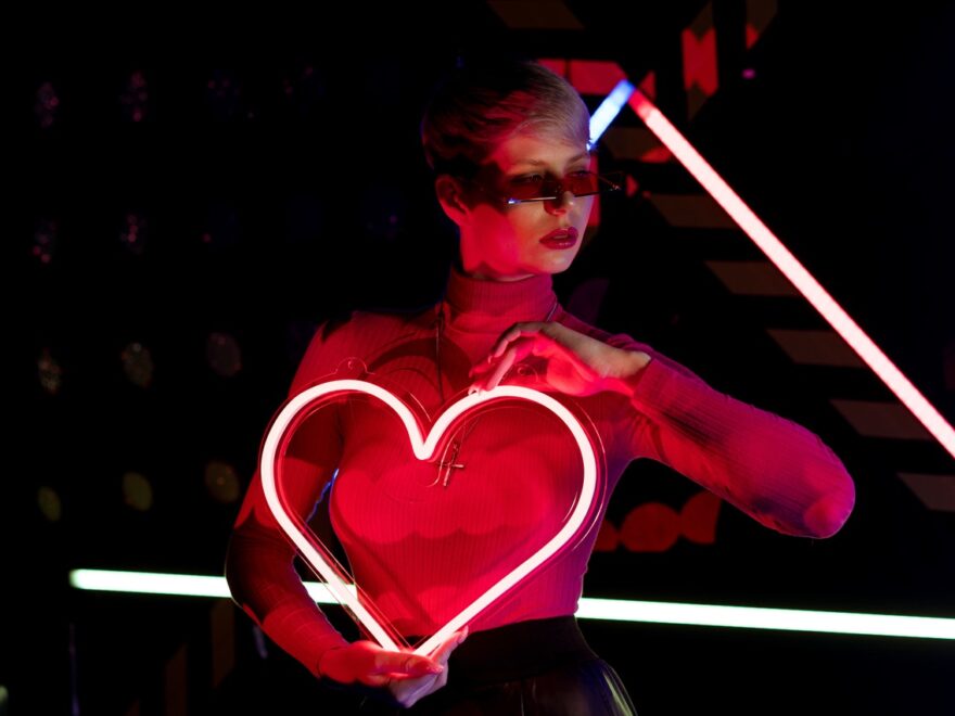 Easter Bunnies header image shows a woman holding a neon heart to her chest