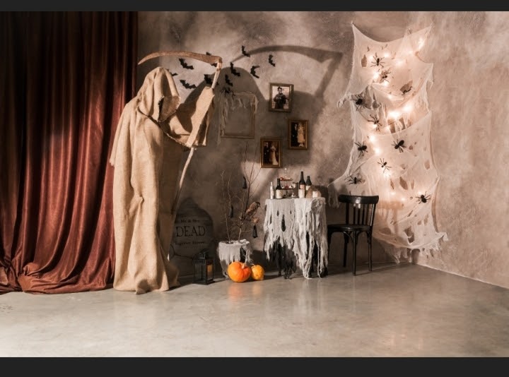 Ghosts goblins and silence header image shows a well lit Halloween scene in still life including Death in a hessian sack, spiders, bats and a tomb stone.