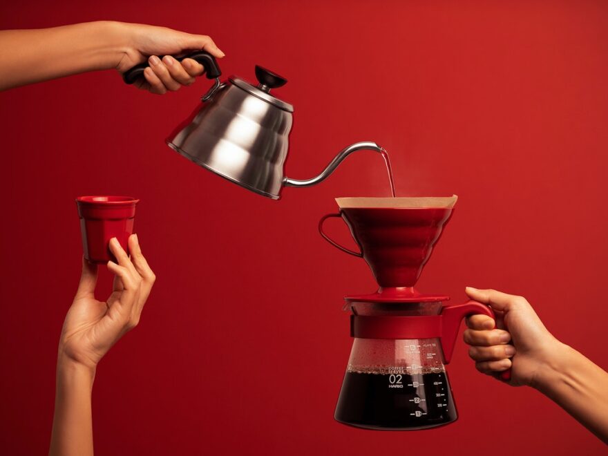 Personal review of 2021 header image shows hand holding kettle pouring water into a coffee maker held by a second hand. While a third hand holds up a cup.