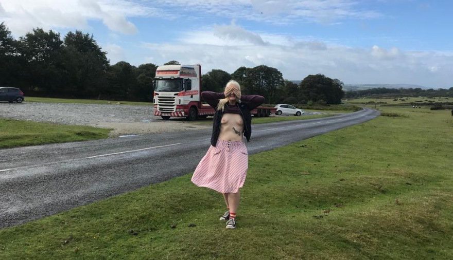 Wagon in the parking area over the road as I stand, exposing my breasts
