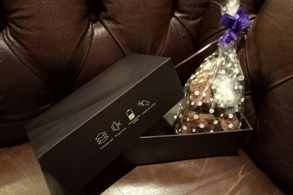 Surprise package of a gift of fudge inside a sex toy box.