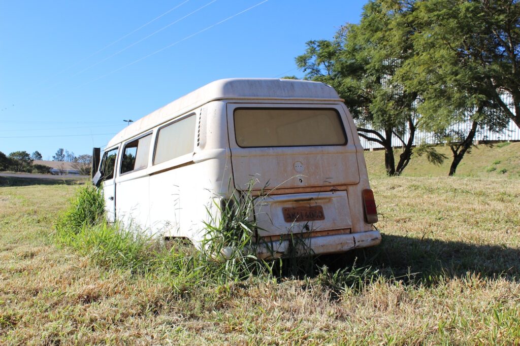 Self-Destruction and turmoil header image shows abandoned camper van in an empty field.