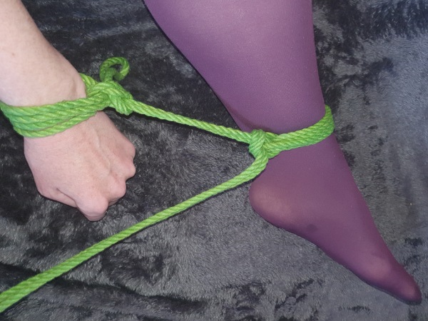 repeating the single column tie from wrist to opposite ankle.