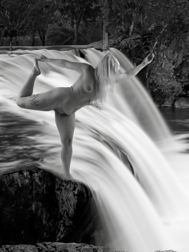 Blonde woman doing Naked Dancer pose atop a waterfall to say whatever your inner wildness looks like, don't be afraid to take that leap of faith