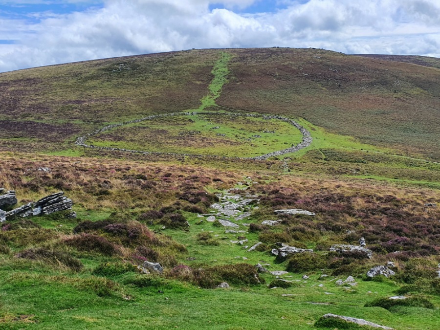 Grimspound from Hookney tor, with the path leading up to Hameldown Tor.