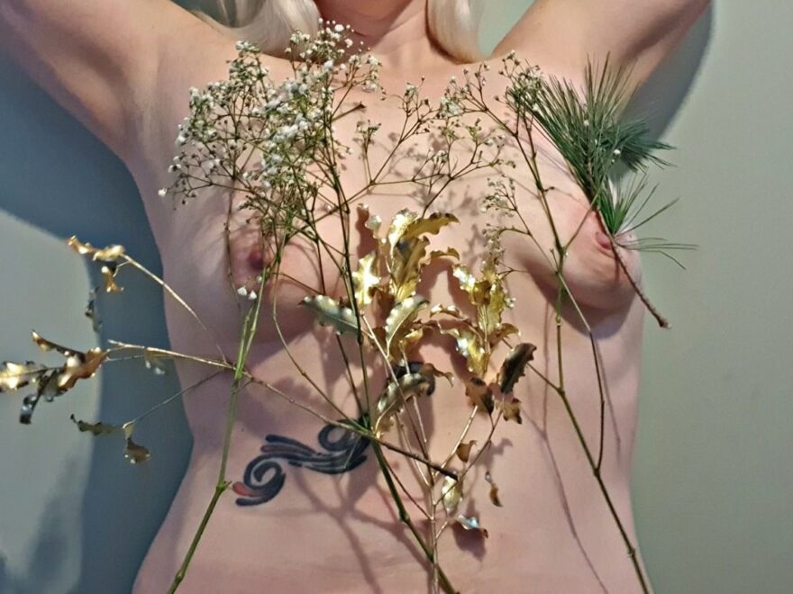 Stapling festive flowers to your torso is possible, I've attached christmas foliage and Gypsophillia to my body using medical stapler.