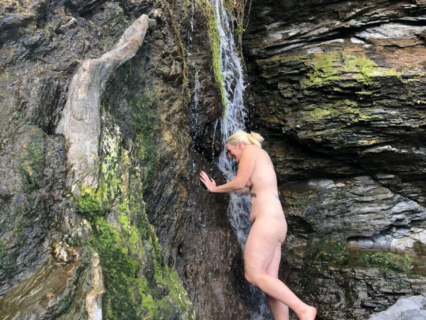 Naked under a beach waterfall, photo by bunny, what is the hidden message.